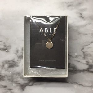 Able gold circle necklace.